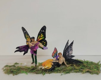 Love fairies.romantic miniature. Man holding girl fairy. garden miniatures fairy couples. Fairy tales.sitting hugging fairy figurines.
