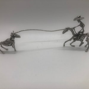 Bones Alive Cowboy Collection Round Up Time features Cowboy Slim on Horse roping a calf cast in Sterling Silver and soldered together.