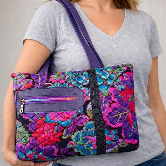Quilted Black, Purple, Green, Pink Laffe Fassett bag with Batik Accent.  Faux Leather Handles and Zipper Facing.
