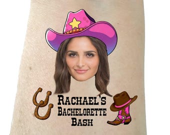 May include: A temporary tattoo with a pink and purple cowboy hat, a woman's face, two brown horseshoes, a brown cowboy boot with a pink top, and the text "Rachael's Bachelorette Bash".