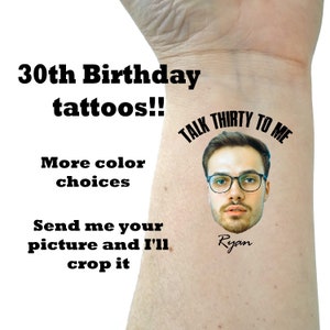 May include: A temporary tattoo with the text "Talk Thirty To Me" and a person's face with the name "Ryan" written below. The tattoo is on a person's wrist.