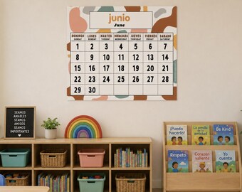 May include: A wall calendar for the month of June featuring a grid with days of the week in Spanish and English, set against a background of abstract shapes in muted tones of brown, pink, teal, and cream, with black numbers from 1 to 30.