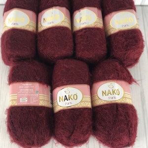 May include: Eight skeins of burgundy yarn with the label "NAKO Paris" on each skein.