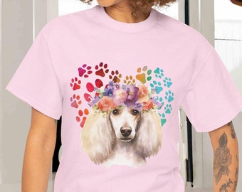 May include: A pink t-shirt with a watercolor illustration of a poodle wearing a flower crown. The poodle is surrounded by rainbow paw prints.
