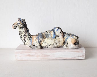 Desert camel with sandy colours, ceramic sculpture on timber mount, Sahara nomad art