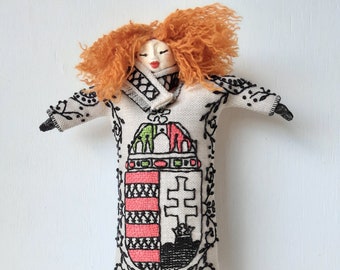 Red haired doll with Hungarian embroidered St Stephen's crest on beige linen body and ceramic body parts, bedroom decor