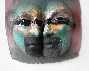Double headed ceramic wall sculpture with black and white, turquoise brushwork glazed surface