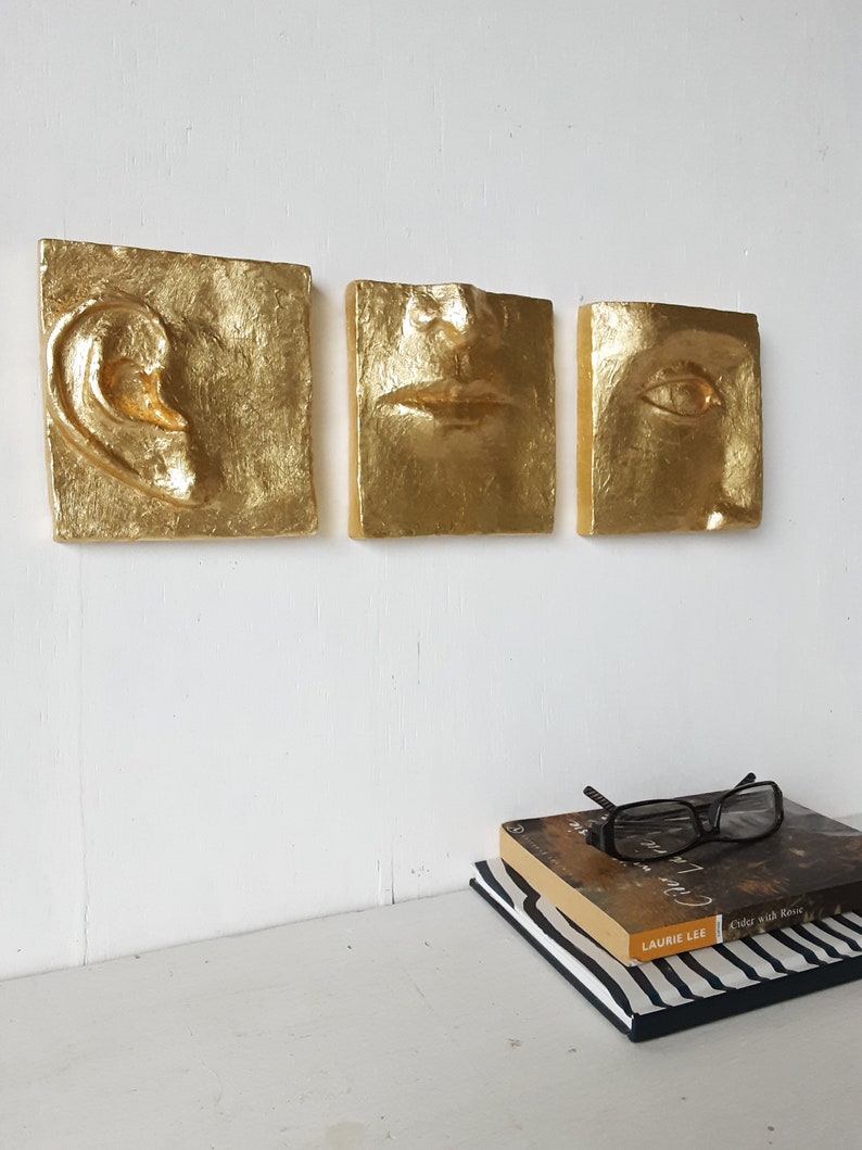 Three part ceramic wall sculpture with gold leaf surface