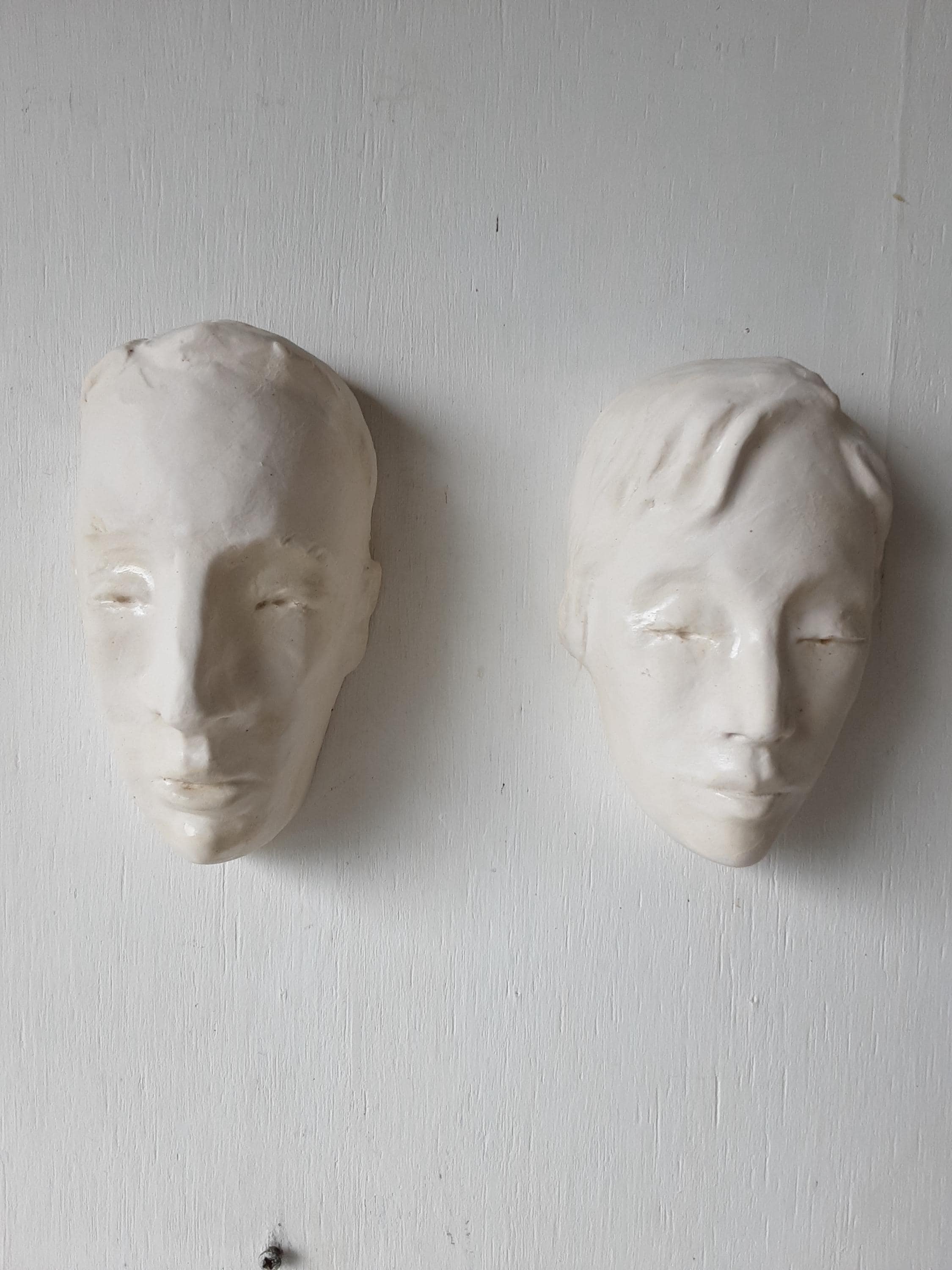 Pair of white male and female ceramic heads, matching wall sculptures, housewarming gift