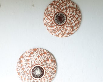 Pair of white and terracotta ceramic wall plaques with geometric swirling pattern, housewarming gift