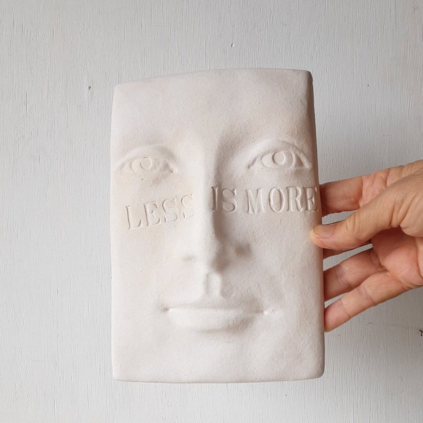 LESS IS MORE wall sculpture of white ceramic face, minimalist wall decor for art lover, gift from Louise Fulton Studio