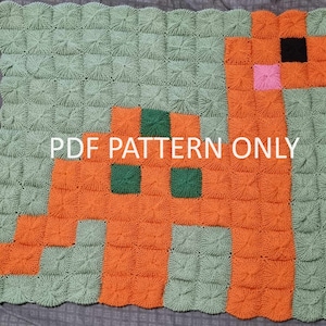 May include: A crochet blanket featuring a pixelated dinosaur design in orange, green, black, and pink. The blanket is made with a textured stitch and has a scalloped edge. The text "PDF PATTERN ONLY" is printed on the blanket.