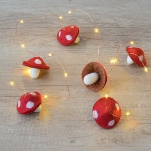 Felt mushroom fairy lights.   Red and white magic mushroom garland.  Warm white fairy lights. Autumn woodland decoration.