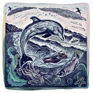 May include: A square linocut print featuring a large dolphin leaping above a dark blue sea with waves, a small fishing boat, and a fish. The border contains text describing the scene in shades of blue, cream, and soft pink with a starfish.