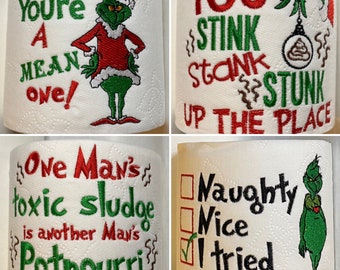 May include: Four different designs of toilet paper rolls featuring the Grinch from the movie How the Grinch Stole Christmas. The designs include the text "You're a mean one!" "One Man's toxic sludge is another Man's Potpourri" "You stink, stank, stunk up the place" and "Naughty, Nice, I tried".