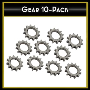 May include: Ten silver-colored metal gears, each with a circular shape and a toothed edge. The gears are arranged in a random pattern on a white background. The text "GEAR 10-PACK" is printed in black at the top of the image.