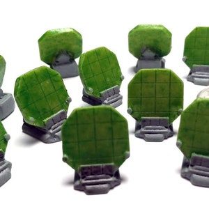 May include: Ten miniature green radar dishes on gray bases. The dishes are octagonal and have a grid pattern. The bases are slightly rounded.