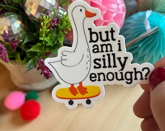 May include: A white goose sticker with an orange beak and feet, standing on a yellow skateboard. The sticker features the black text "but am i silly enough?" in a bold, sans-serif font. The design is die-cut with a white border around the edges.