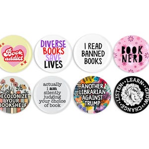 May include: Eight circular badges with book-related slogans. The designs include phrases such as "Book Addict," "Diverse Books Save Lives," and "I Read Banned Books." The colour palette includes pink, yellow, white, and black.
