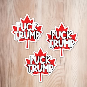 May include: Three red maple leaf stickers with a white border. Each sticker features the text FUCK TRUMP in bold, black-outlined white capital letters centred on the leaf. The design is consistent across all three individual sticker units.