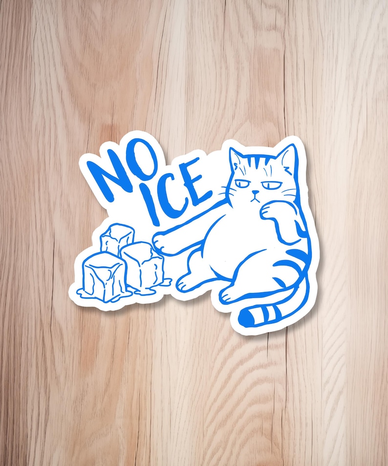 May include: A white sticker with a blue outline featuring a grumpy cat and the words "NO ICE." The cat is sitting with its paw under its chin, next to three ice cubes. The sticker is on a wooden surface.