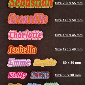 May include: A selection of embroidered name patches in various colours, featuring names like "Sebastian", "Granville", "Charlotte", and "Isabella". Sizes vary from 60mm x 25mm to 200mm x 55mm. Also includes patches with dates and names like "Emme", "Sophie", "Molly", "Jake", and "Uncle".
