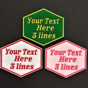 May include: Three hexagon-shaped fabric patches with a red, pink, and green background. Each patch has a yellow outline and the text "Your Text Here 3 lines" embroidered in white, yellow, and white respectively.