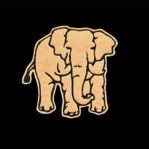May include: A beige embroidered patch of an elephant with black outlines. The elephant is standing with its trunk curled up.