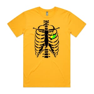 May include: A yellow t-shirt with a black skeleton ribcage design. The heart of the skeleton is replaced with a green and yellow leaf.