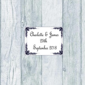 May include: White card with a black decorative border and the text "Charlotte & James 25th September 2018".