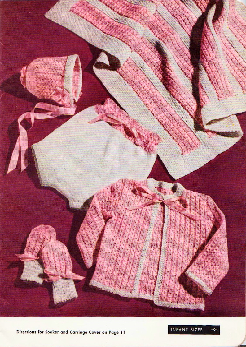 May include: A set of knitted baby clothes in pink and white, including a cardigan, a bonnet, a soaker, and mittens. The text "INFANT SIZES" is visible in the image.