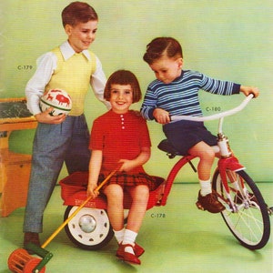 May include: Three children playing with a red wagon and a tricycle. The wagon has a white and red design and a wooden handle. The tricycle is red with a white seat and black wheels. The children are wearing casual clothing. The boy in the blue and white striped shirt is riding the tricycle. The girl in the red shirt is sitting in the wagon. The boy in the yellow shirt is pushing the wagon.