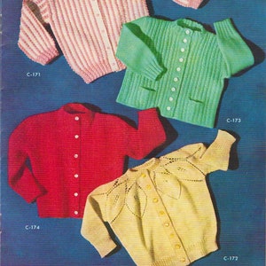 May include: Four knitted toddler cardigans in different colors and patterns. The cardigans are pink and white striped, green, red, and yellow with a leaf pattern. The cardigans are all button-up and have long sleeves.