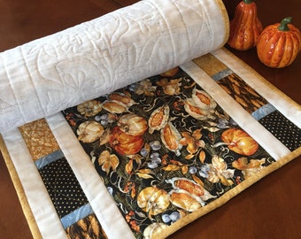 Handcrafted quilted table runner featuring Fall themed colors and prints