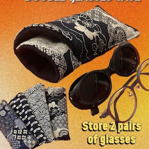 May include: A black and white patterned double glasses case with two pairs of glasses. The case is open, revealing a soft interior. The text "DOUBLE GLASSES CASE" and "Store 2 pairs of glasses" are visible.