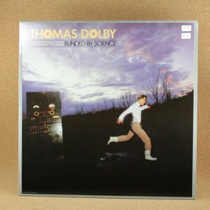 May include: A vinyl record album cover featuring a man running through a field with a cloudy sky in the background. The album cover is for the album "Blinded by Science" by Thomas Dolby.