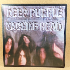 May include: Album cover for Deep Purple's Machine Head. The album art features the band members with long hair, and the album title is in a silver, embossed font. The background has a purple and blue gradient.