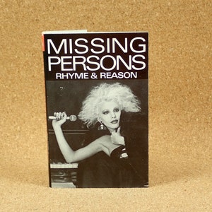 May include: A black and white photo of a woman holding a microphone. The book cover reads "MISSING PERSONS RHYME & REASON".