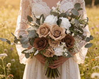 May include: A floral bouquet featuring a mix of white, beige, and dark brown roses, accented with green eucalyptus leaves and small white filler flowers. The arrangement is gathered into a bundle with visible stems at the base, creating a rounded shape.