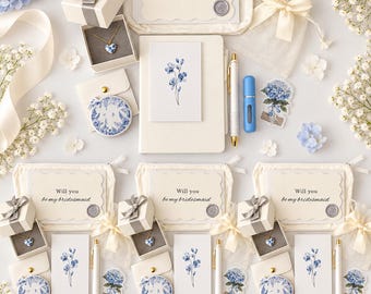 May include: A bridesmaid proposal gift set featuring a cream canvas pouch, a card reading Will you be my maid of honor or bridesmaid, a heart-shaped necklace in a box, a floral notebook, a blue and white compact mirror, a pen, and a sticker.