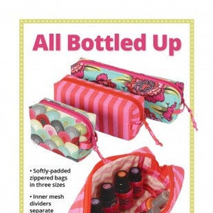 May include: Three pink and white striped zippered pouches with a floral design. The pouches are lined with mesh dividers to separate and protect bottles. The largest pouch is open to show the interior with several small bottles inside. The text "All Bottled Up" is at the top of the image. The text "ByAnnie's Soft and Stable® gives great body and stability plus cushioning for the bottles. Great for gifts, too!" is at the bottom of the image.