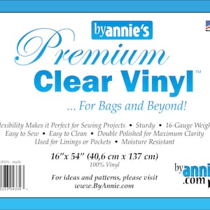 May include: A roll of clear vinyl, 16 inches by 54 inches (40.6 cm by 137 cm), labeled "byannie's Premium Clear Vinyl" and "For Bags and Beyond!"  The vinyl is 100% vinyl and is described as flexible, sturdy, 16-gauge weight, easy to sew, easy to clean, double polished for maximum clarity, used for linings or pockets, and moisture resistant. The label also includes the text "SUP151-1654" and "www.ByAnnie.com".