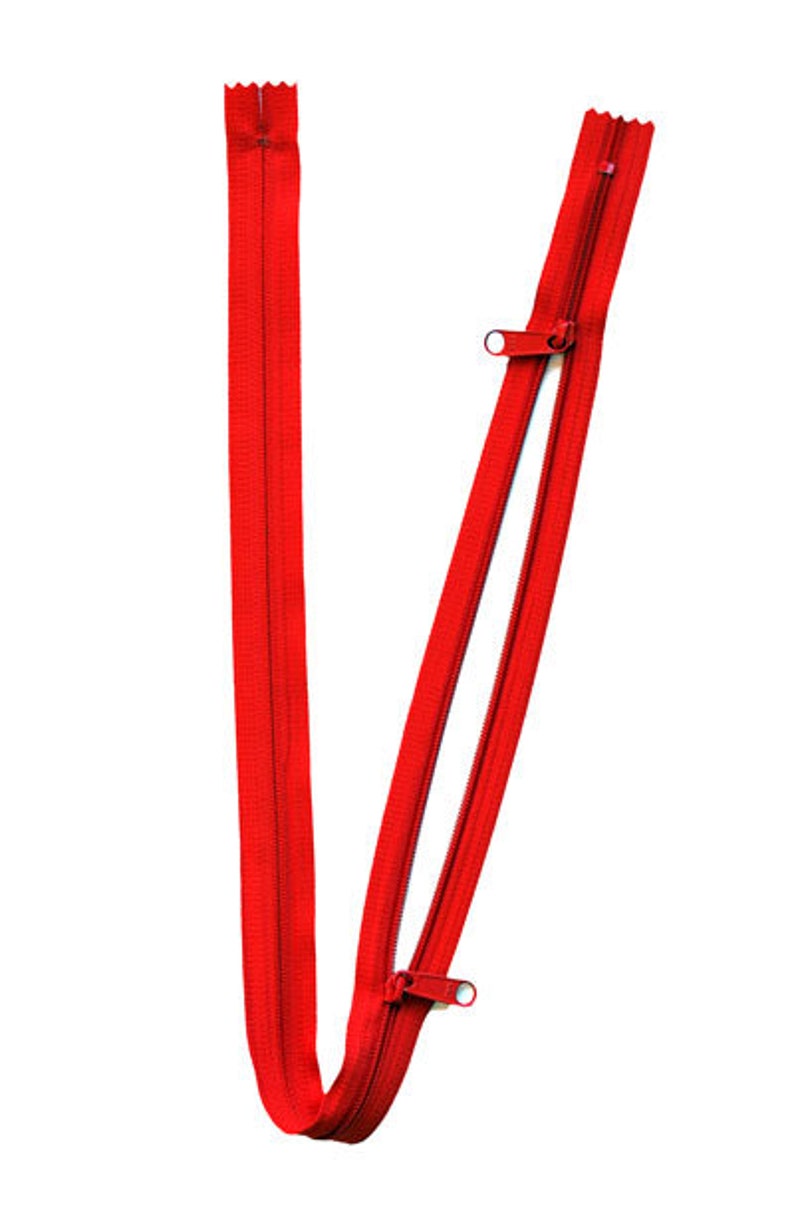 May include: A red zipper with two sliders. The zipper is open and the sliders are at the top of the zipper.