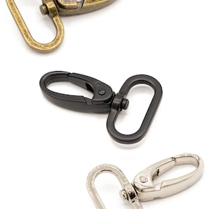 May include: Three metal swivel clasps in different finishes: antique brass, black, and silver.