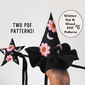 May include: A black felt witch hat and star-shaped wand featuring pink flower appliqués, lavender crescent moons, and white embroidered stars. Text reads: TWO PDF PATTERNS! and Witches Hat & Wand PDF Patterns. The items are crafted from dark fabric.