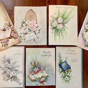 May include: A collection of vintage sympathy cards with floral designs and religious imagery. The cards feature phrases like "Our Comfort to You", "A Message of Sympathy", "May God Comfort You", and "A Thought to Comfort You".