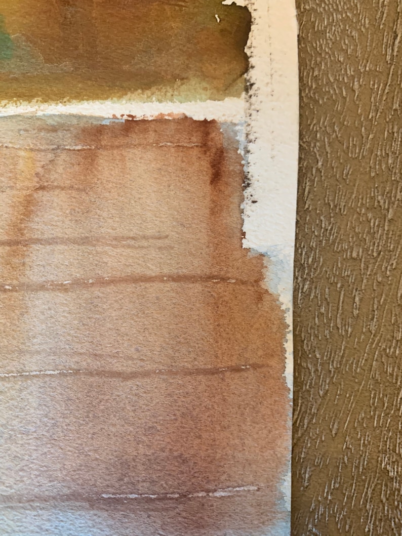 May include: Watercolor painting with a textured, layered effect. The artwork features shades of brown and tan, with visible brushstrokes and a rough, unfinished edge. The painting's composition is abstract, with horizontal lines and a blend of colors.