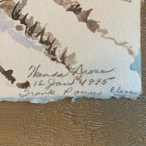 May include: Watercolor painting of a winter landscape in shades of brown, gray, and white. The artwork is signed "Nanda Drose" and dated "12 Jan 1955". The title "Drave Louise Class" is also included. The paper has a torn edge.