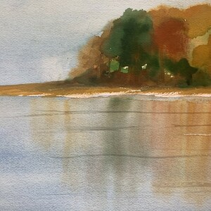 May include: Watercolor painting of a serene landscape featuring a body of water reflecting the sky and the colors of the trees on the shore. The trees display shades of green, brown, and yellow, suggesting an autumn scene.