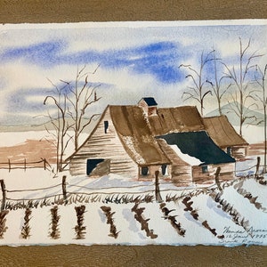 May include: Watercolor painting of a barn in a winter landscape. The barn has a brown roof and white walls, with snow on the ground and a blue sky. Bare trees and a fence are also visible. The painting is signed and dated.